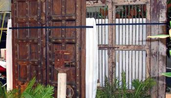 Antique Indian Door with Metal Studding detail, plus Antique Indian Gates in background